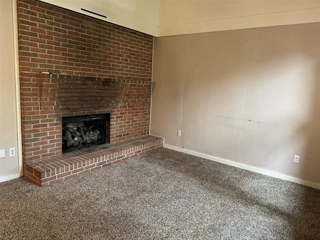 unfurnished living room with carpet floors and a brick fireplace