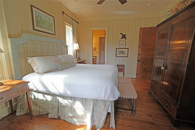 bedroom featuring wood finished floors, crown molding, ensuite bath, wooden ceiling, and ceiling fan
