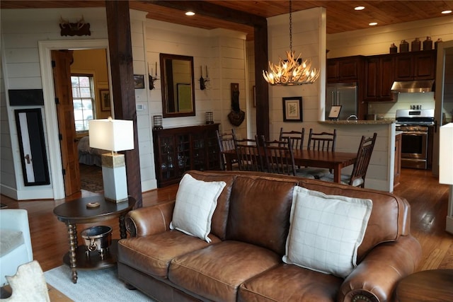 living area featuring wooden ceiling, recessed lighting, wood finished floors, and a chandelier