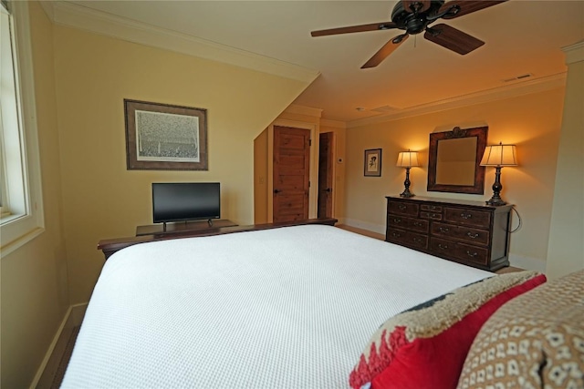 bedroom with crown molding, baseboards, and a ceiling fan