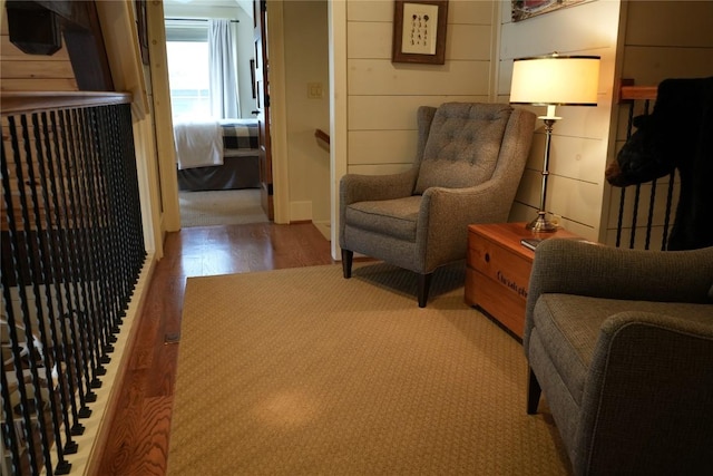 living area featuring wood finished floors and wood walls