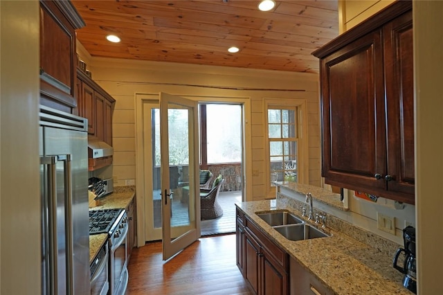 kitchen featuring stainless steel appliances, a sink, wood ceiling, light wood finished floors, and recessed lighting