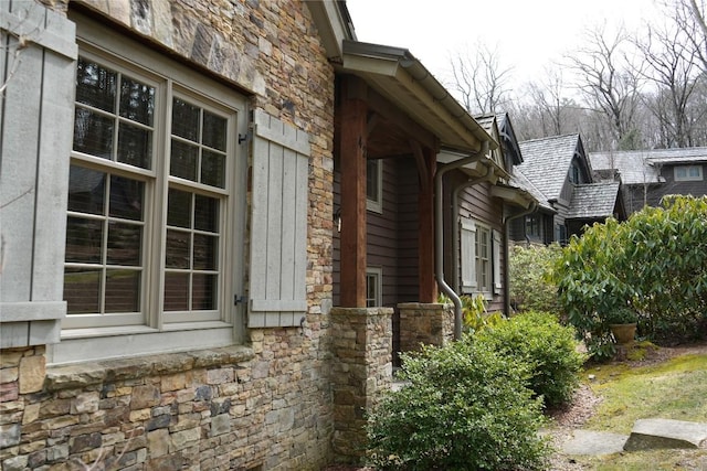 view of side of property with stone siding