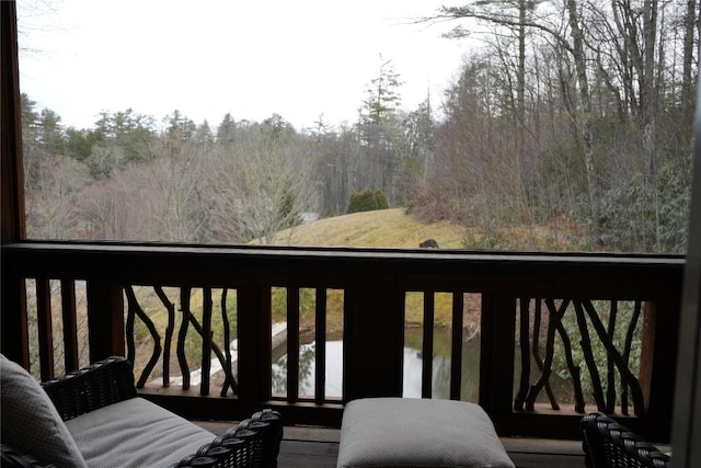 balcony featuring a forest view