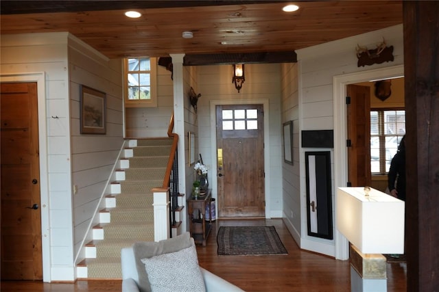 entrance foyer with wooden ceiling, wood finished floors, stairs, recessed lighting, and wood walls