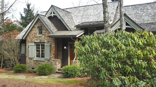 doorway to property featuring crawl space and stone siding