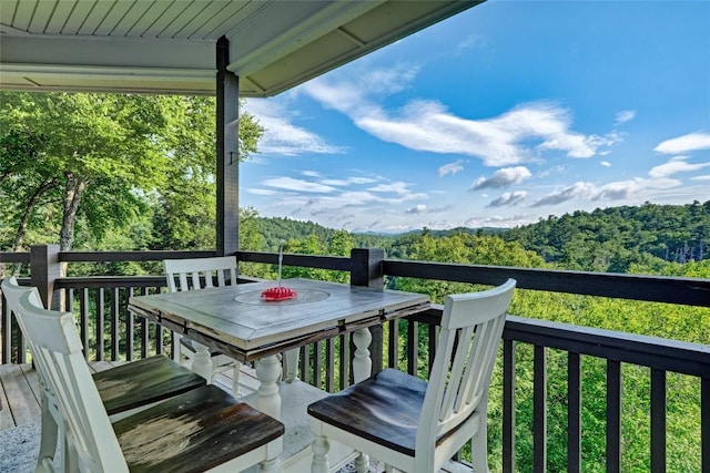 wooden deck featuring a forest view