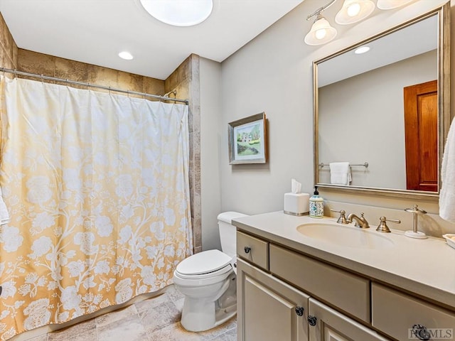 bathroom with vanity, toilet, and walk in shower