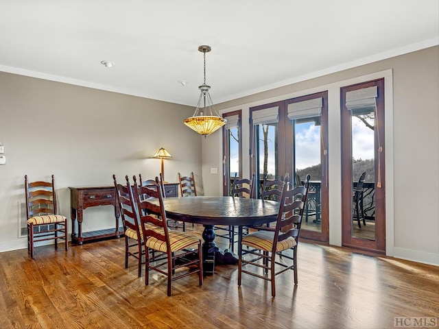 dining space with french doors, ornamental molding, and dark hardwood / wood-style floors