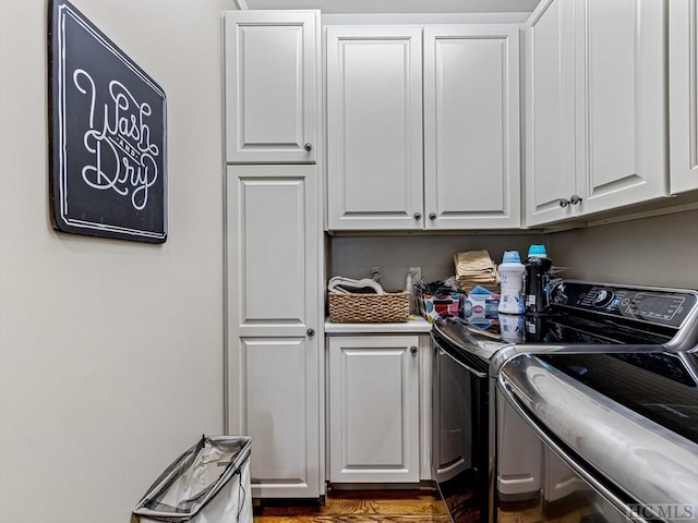 washroom with cabinets and washing machine and clothes dryer