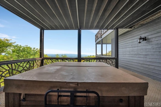 wooden deck with a hot tub