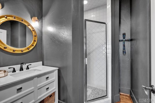 bathroom featuring vanity and an enclosed shower