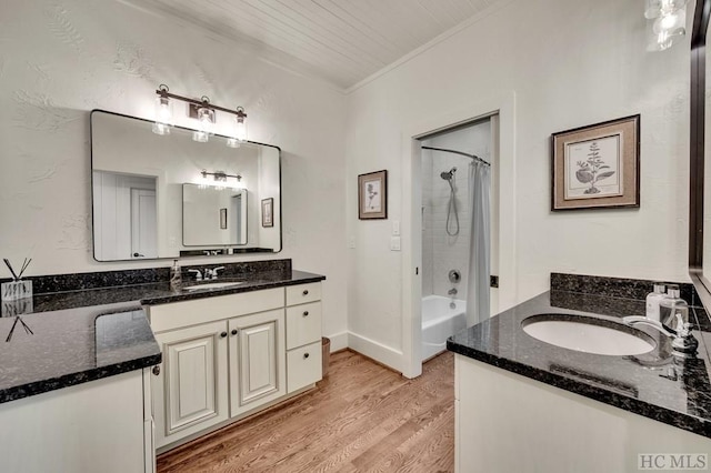 bathroom featuring ornamental molding, wood-type flooring, shower / bath combo, and vanity