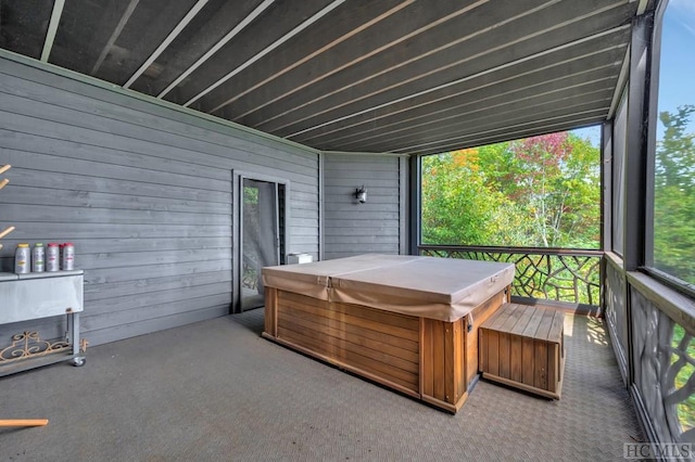 sunroom with a hot tub