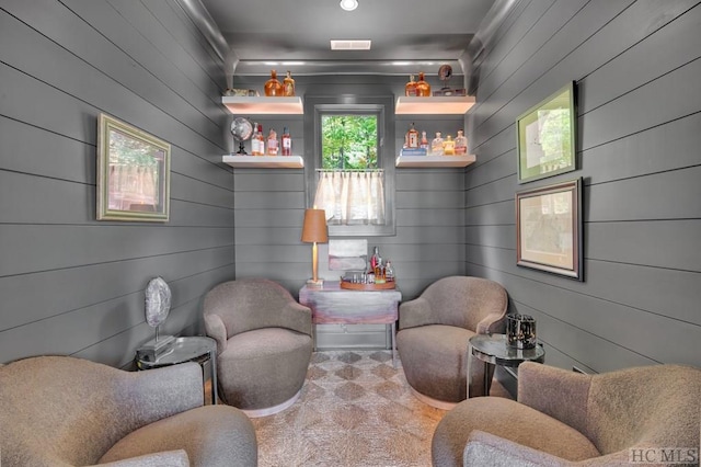 living area featuring wooden walls