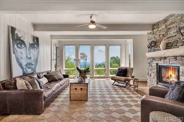 living room featuring a fireplace and ceiling fan