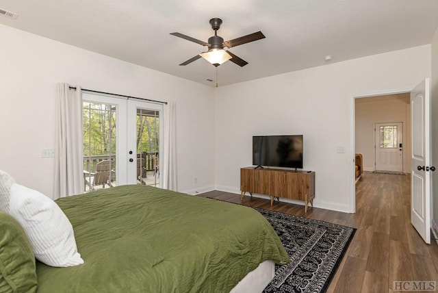 bedroom featuring dark hardwood / wood-style floors, access to exterior, ceiling fan, and french doors