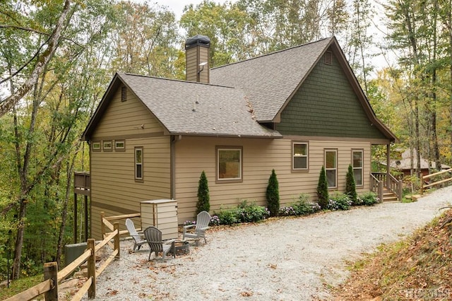 back of house with a fire pit