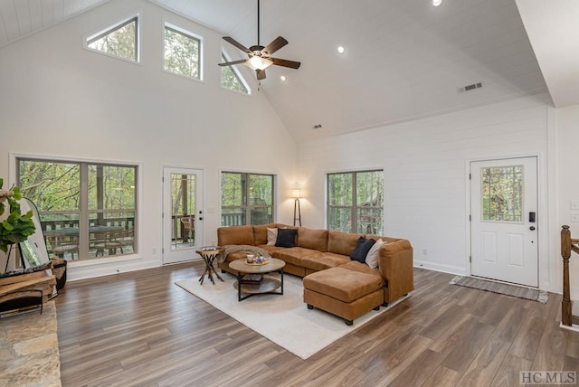 living room with ceiling fan, dark hardwood / wood-style flooring, and high vaulted ceiling