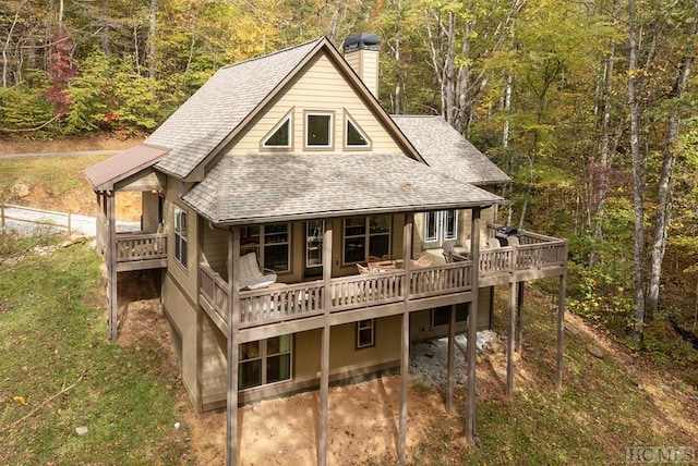 back of property featuring a wooden deck