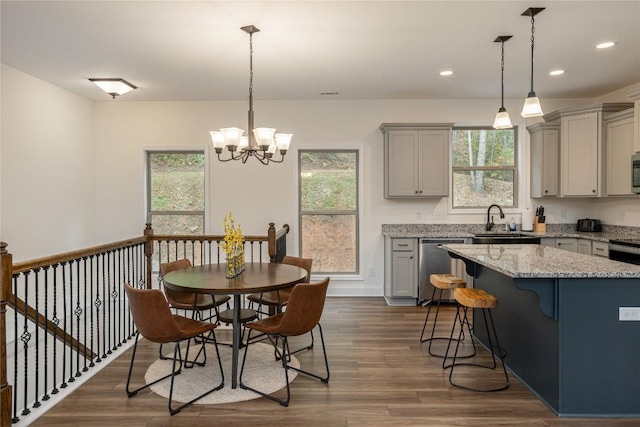 kitchen with gray cabinetry, appliances with stainless steel finishes, a sink, plenty of natural light, and recessed lighting