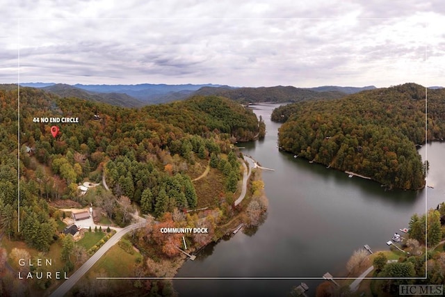 drone / aerial view featuring a water and mountain view