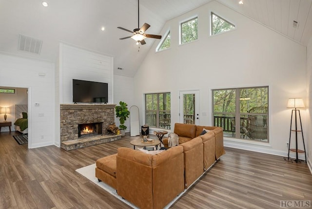 living room with dark hardwood / wood-style floors, high vaulted ceiling, and a wealth of natural light