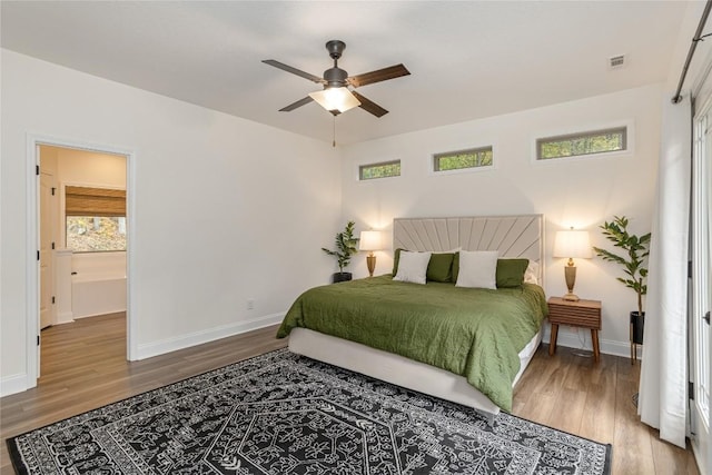 bedroom featuring wood finished floors, baseboards, and ceiling fan