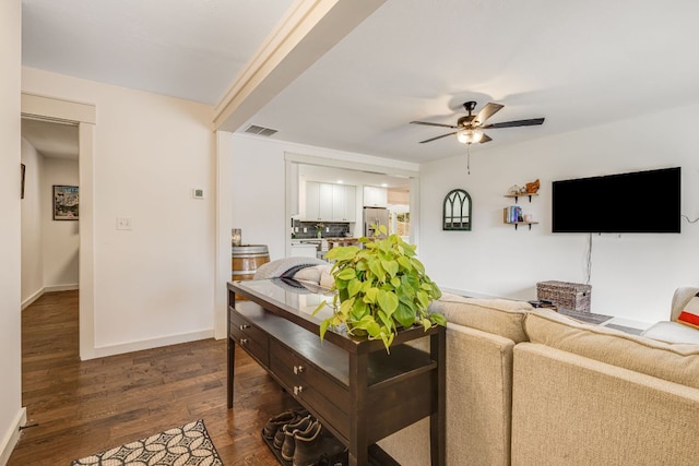 living room with ceiling fan and dark wood-type flooring