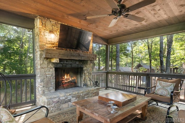 sunroom featuring ceiling fan, wood ceiling, and a healthy amount of sunlight