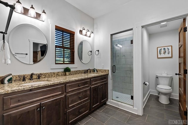 bathroom featuring walk in shower, vanity, toilet, and tile patterned flooring