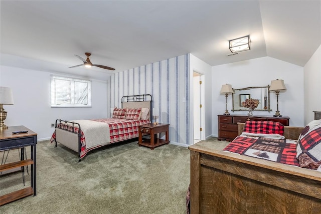 carpeted bedroom featuring vaulted ceiling, wallpapered walls, a ceiling fan, and baseboards