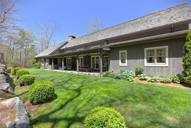 212 Ivorybill Way, Cashiers, NC 28717 - rear view of house featuring a yard, a patio, and a chimney