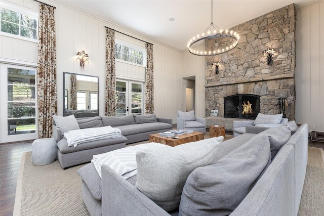212 Ivorybill Way, Cashiers, NC 28717 - living area with crown molding, an inviting chandelier, plenty of natural light, and hardwood / wood-style flooring