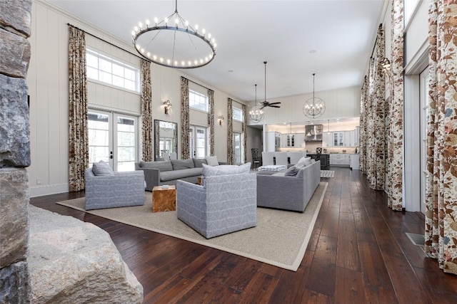 212 Ivorybill Way, Cashiers, NC 28717 - living room with a notable chandelier, dark wood finished floors, and a towering ceiling