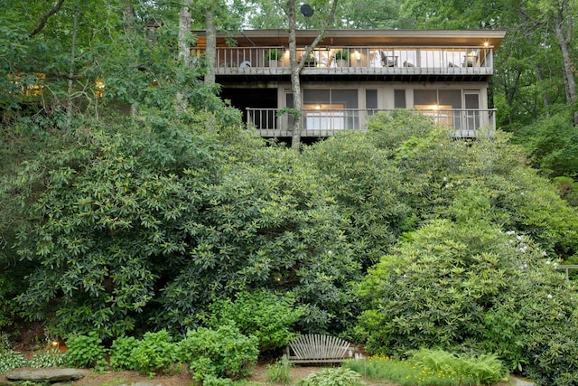 rear view of property featuring a balcony