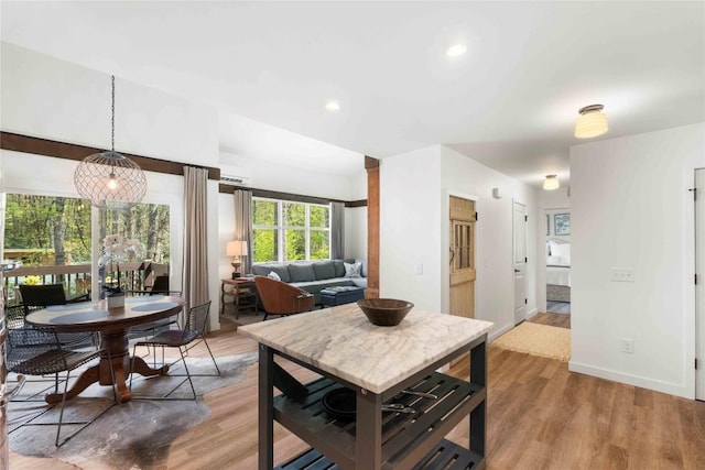 dining space featuring recessed lighting, baseboards, and light wood finished floors