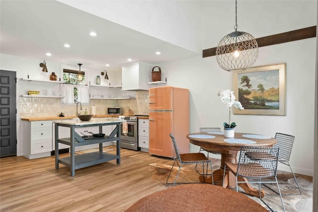 kitchen featuring decorative backsplash, appliances with stainless steel finishes, open shelves, light wood finished floors, and recessed lighting