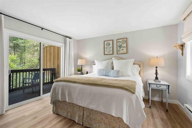 bedroom with light wood-style floors, multiple windows, and access to exterior