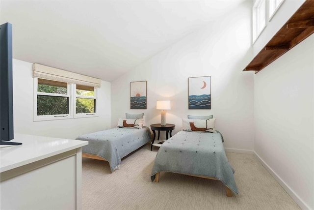 bedroom with baseboards, light carpet, and vaulted ceiling