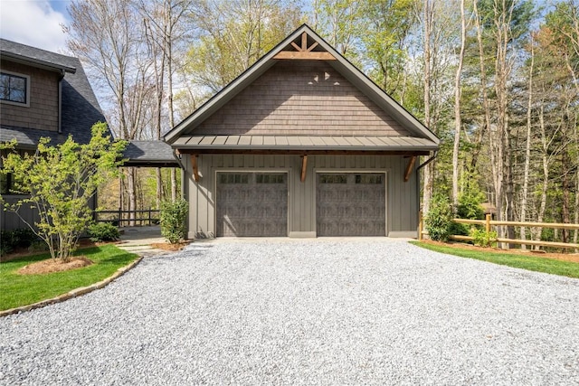 detached garage with fence and driveway