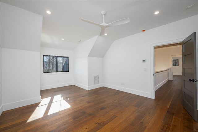 additional living space featuring dark wood-style flooring, baseboards, vaulted ceiling, and recessed lighting