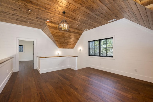 additional living space with wood ceiling, vaulted ceiling, and dark hardwood / wood-style floors