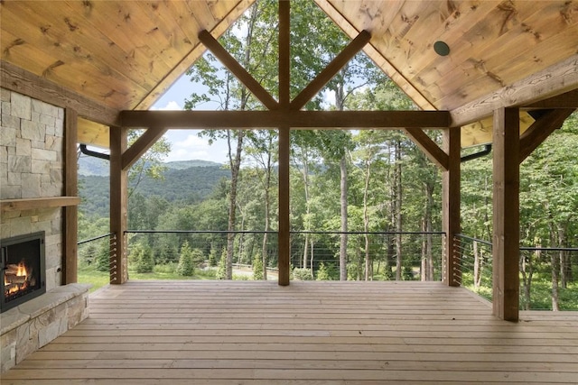 237 Glassy Rock Ln, Glenville, NC 28736 - wooden deck with an outdoor stone fireplace, a wooded view, and a mountain view