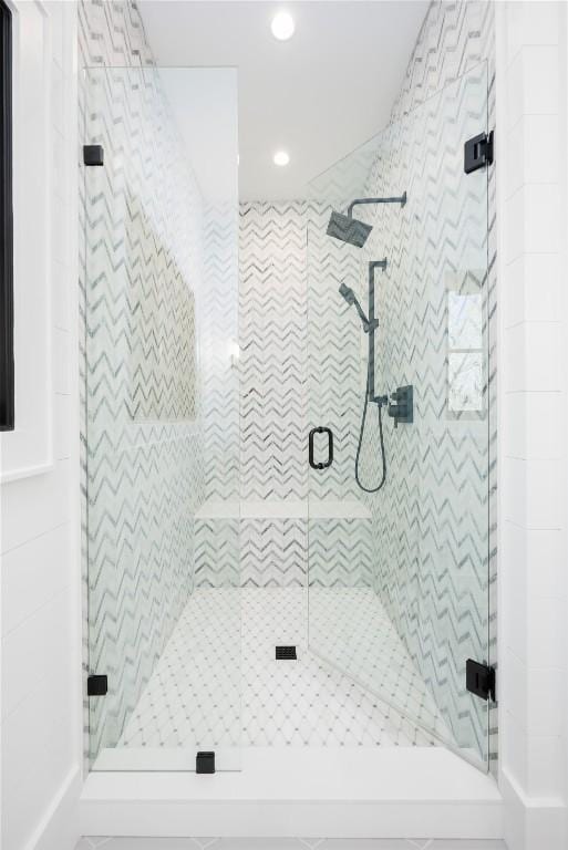 bathroom featuring a shower with shower door