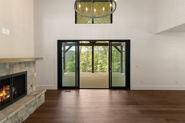 237 Glassy Rock Ln, Glenville, NC 28736 - unfurnished living room with dark wood-style flooring, a fireplace, and a high ceiling