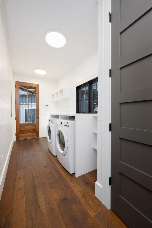 clothes washing area featuring laundry area, dark wood-style flooring, and independent washer and dryer