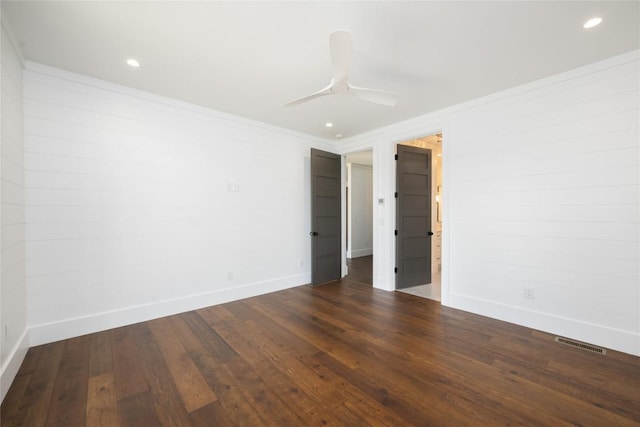 spare room featuring ornamental molding, dark hardwood / wood-style floors, and ceiling fan