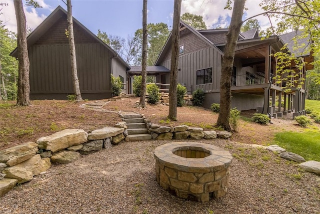 237 Glassy Rock Ln, Glenville, NC 28736 - rear view of house with board and batten siding and a fire pit