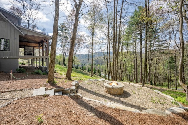 view of yard featuring an outdoor fire pit and a mountain view